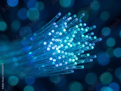 Принти на полотні Glowing Blue and Cyan Fiber Optic Cables Transmitting High Speed Data with Bokeh