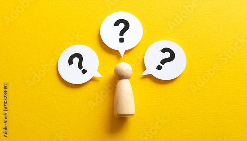 Wooden Peg Doll with Question Mark Speech Bubbles on Yellow Background