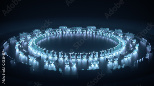 Photos Circular arrangement of glowing office desks and chairs under blue lighting, forming a large ring in a dark room with reflective floor