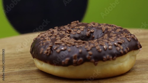 Dark chocolate donut on wood table.