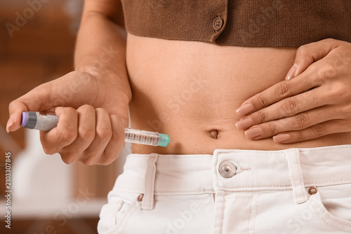 Woman injecting insulin int...