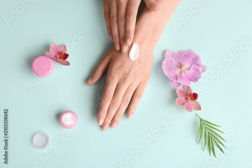Woman applying hand cream w...