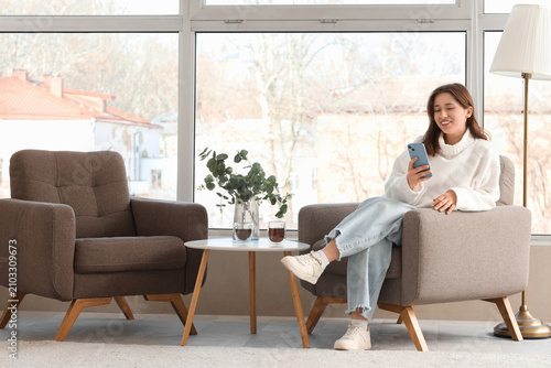 Young woman using mobile ph...