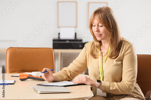 Female bank manager working...
