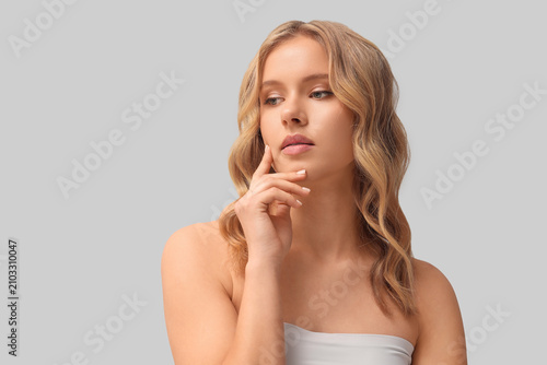 Blonde young woman with cur...