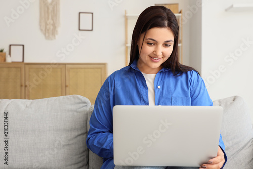 Beautiful young woman using...