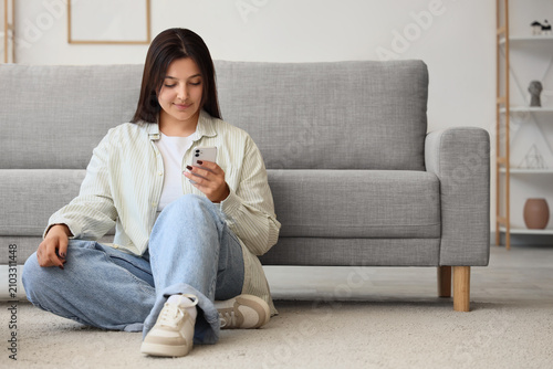 Beautiful young woman using...