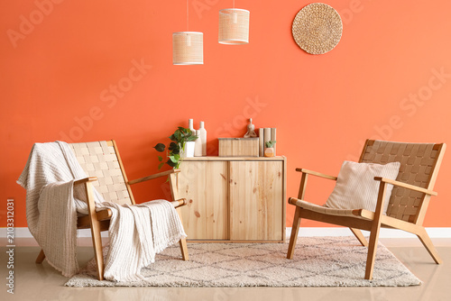 Konstfotografi Interior of stylish living room with wooden armchairs and commode