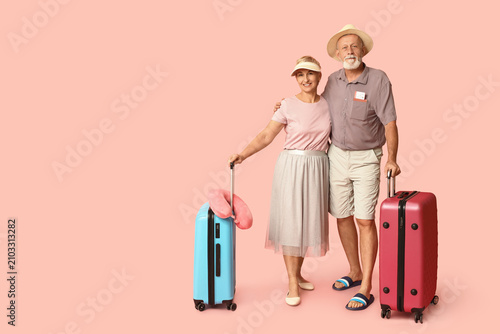 Mature couple with suitcase...