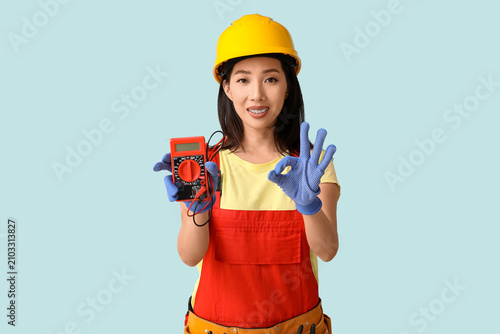 Young female electrician wi...