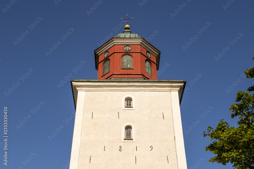 Fototapeta premium Historic Thorslunda church tower dated eighteen nineteen on Oland Sweden