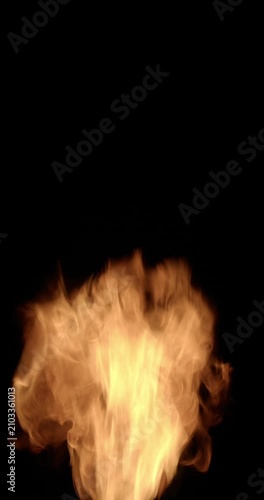 Intense flames burst upward from the bottom of the frame, creating a dramatic fire explosion with swirling fire trails, glowing particles, and organic flame patterns.