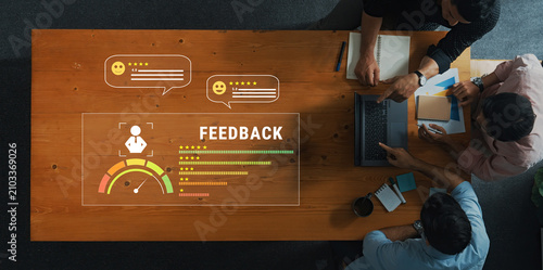 Konstfotografi A dynamic team collaborates in a modern workspace, utilizing digital feedback tools and interactive ratings, fostering innovation and communication effectively