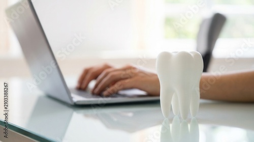 Managing a dentist bill and dental insurance online using a laptop computer.