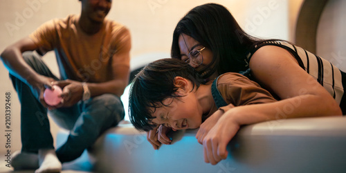 Diverse family sharing happy moments and playful interaction with child