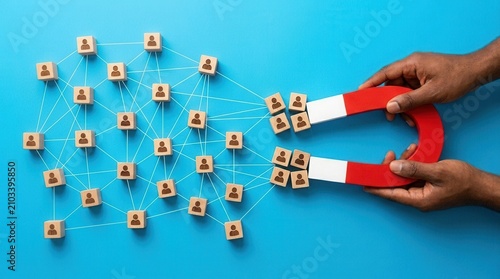 Hands holding a magnet to attract a network of customer person icons.