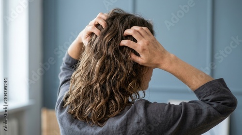 Problematic dry scalp and itchy hair being scratched by hands.