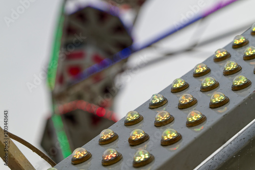 фотографія Illuminated carnival ride lights with blurred amusement park background