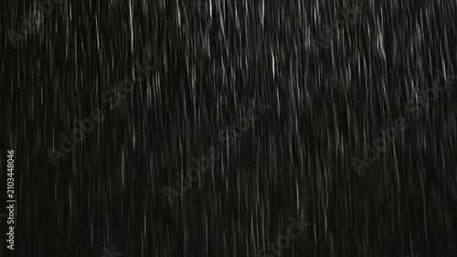 A heavy downpour of rain falling against a dark background
