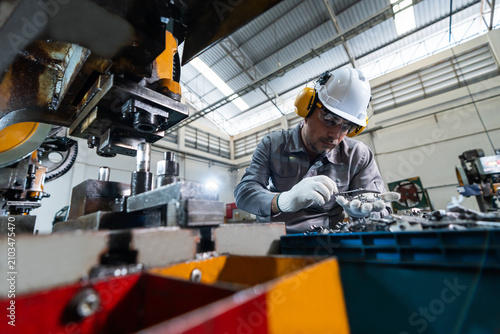 Konstfotografi A white male factory worker in workwear,hard hat,protective glasses and earmuffs