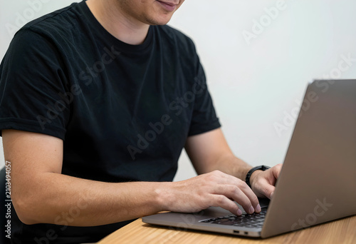 Unrecognizable man typing o...