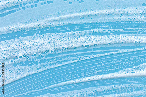 Close-up of foam pooling on a blue backdrop