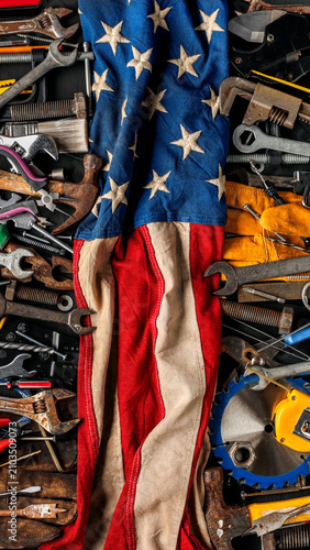 Worn work tools with the American flag. Symbolic of blue collar workers, USA manufacturing, pride in products Made in United States of America, or celebrate Father's day or US Labor Day.
