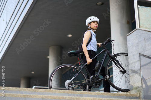 The woman cycles to work at the office.