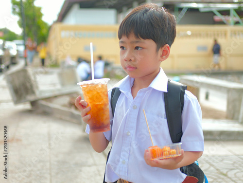 A Thai first-grade student buys food after school.