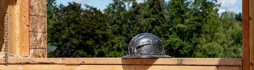 Bild auf Leinwand Construction worker black hard hat, helmet, sitting in a framed out window openi