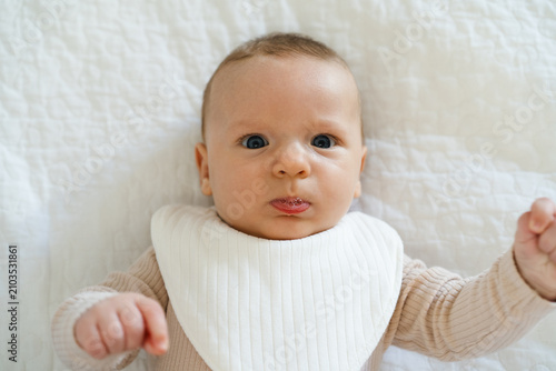 Fotografie Portrait of a two to three month old baby with visible drool on lips