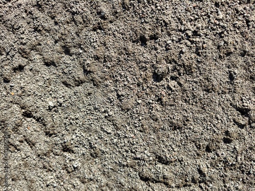 Close up texture of dry coarse sand and gravel on ground surface