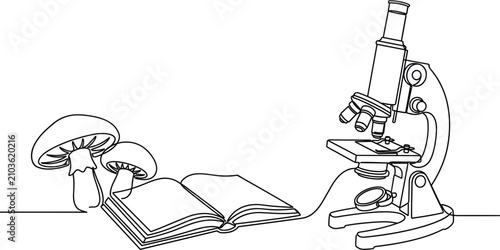 Tableau sur toile Scientific study of mushrooms featuring optical microscope open textbook and fungal specimens for biological laboratory research