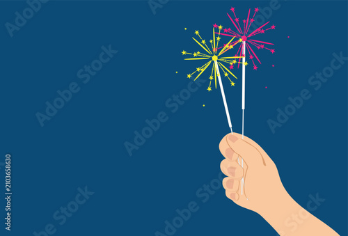 Human hand holding colorful sparkling celebration lights with vibrant glowing particles.