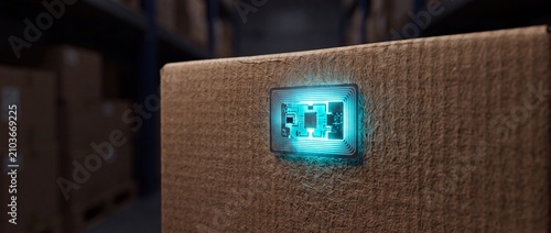 Glowing electronic rfid chip attached to brown cardboard box surface representing advanced smart tracking technology in modern global logistics network