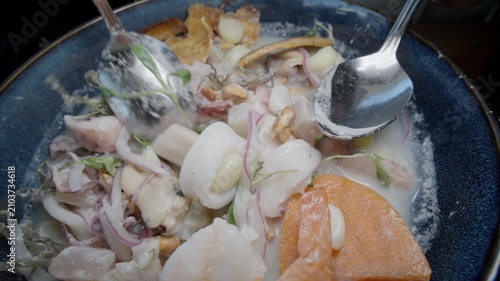 Mixing up a bowl of Peruvian ceviche
