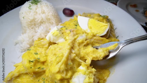 Aji de Gallina served on a bed of rice. Typical Peruvian food