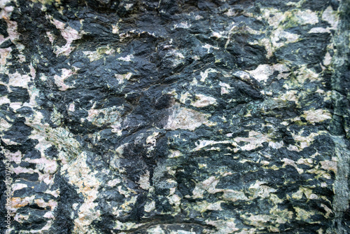 Close-up view of textured granite rock surface with natural patterns