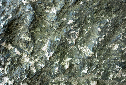 Close up view of textured surface of serpentinite or serpentine with mineral patterns and colors
