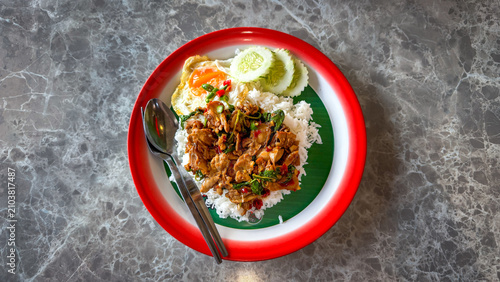 Rice topped with stir-fried duck and basil with fried egg