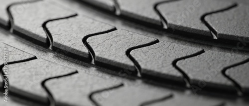 Detailed close-up of a black rubber surface, highlighting the deep geometric pattern and rough texture.