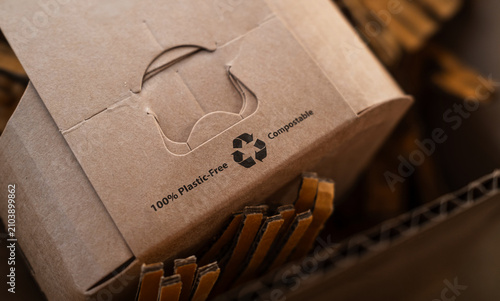 Close-up of recyclable cardboard packaging with reuse symbol, plastic-free concept. Sustainable materials and eco-friendly branding for environmental awareness.