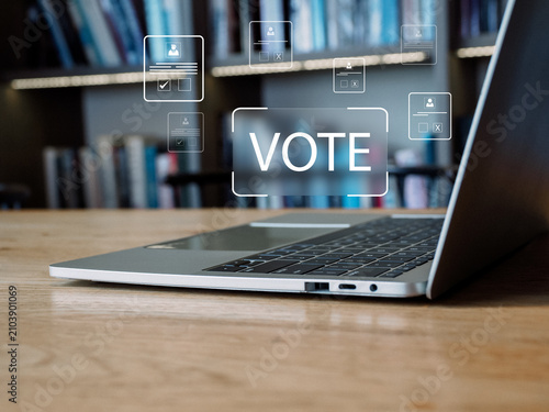 Canvas Print Online vote button over laptop keyboard in library workspace conveying civic eng