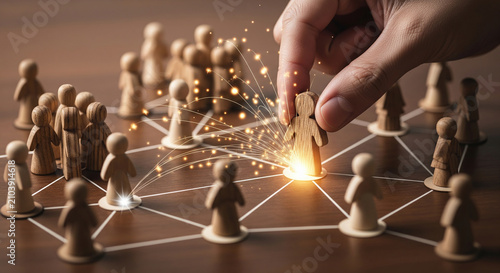 Businessman placing a glowing wooden figure into the center of a network, representing influence and strategic connection