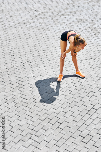 Sportswoman resting during workout outdoors
