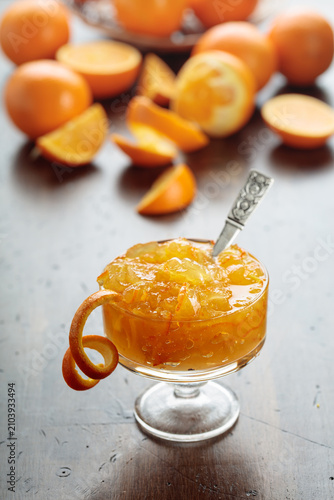 фотографія Orange jam in a glass dessert bowl on an old wooden table.
