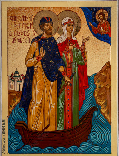 Фотография Orthodox christian icon depicting holy saints Peter and Fevronia of Murom standing in a wooden boat on water, close up details
