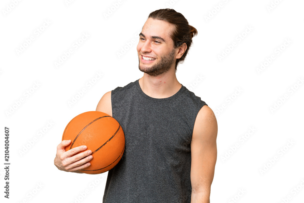 Obraz premium Young basketball player man over isolated background looking to the side and smiling