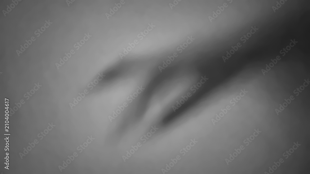 Obraz premium Shadow of a hand reaching out on a plain wall in low light