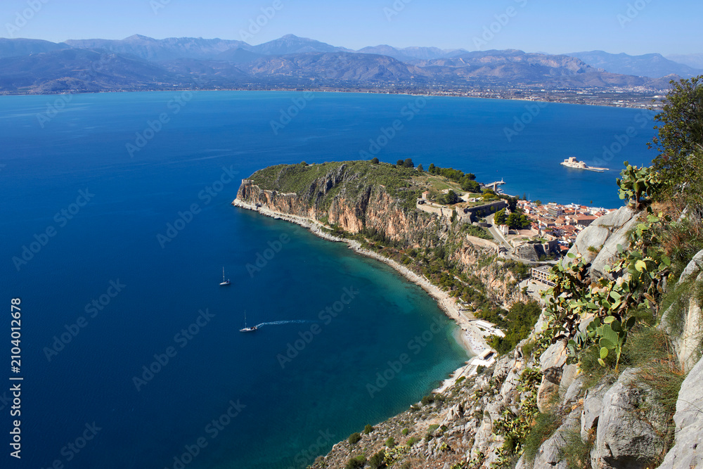 Fototapeta premium High angle view of Acronauplia fortress and Nafplio town with cactus plant in the foreground under a clear sky in Greece